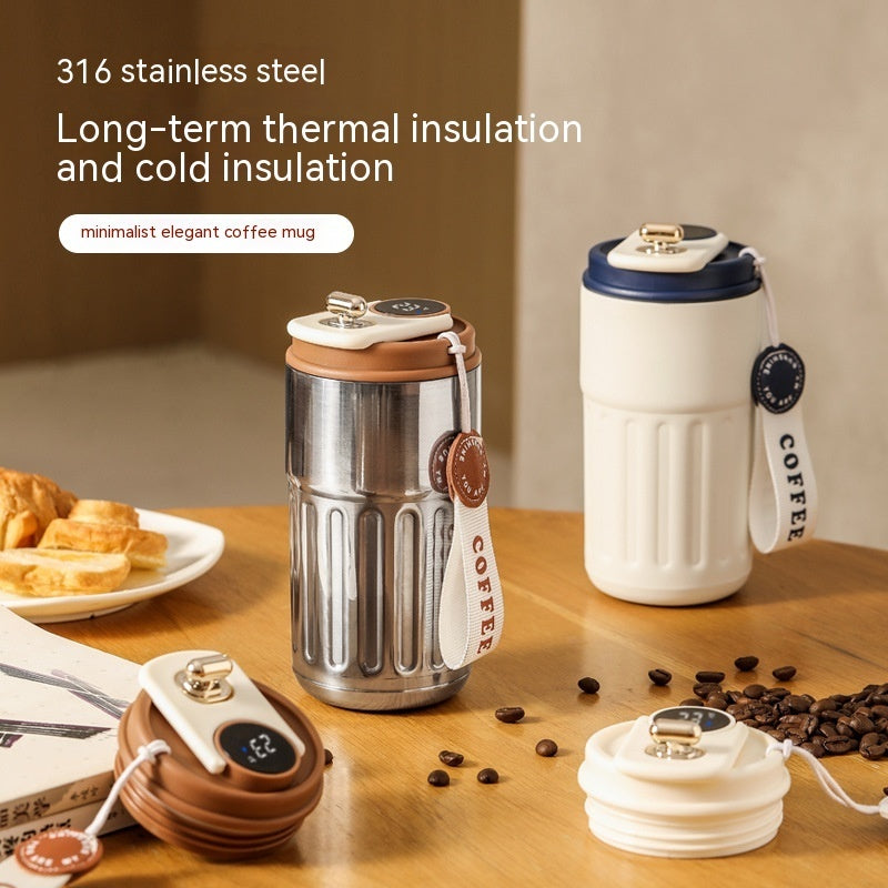 An arrangement of minimalist coffee mugs and accessories on a wooden table.