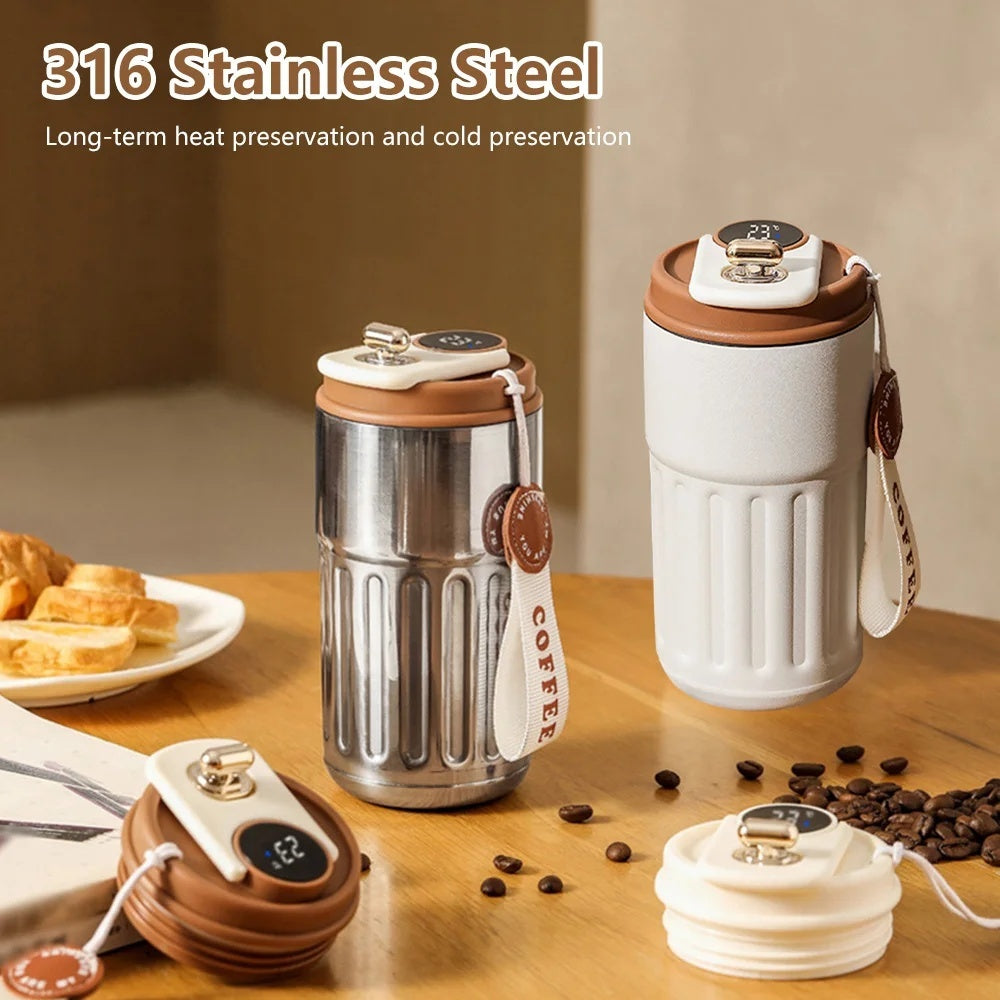 Product shot of two stainless steel coffee thermoses with brown accents and digital temperature display alongside detachable lids, coffee beans, and pastries.